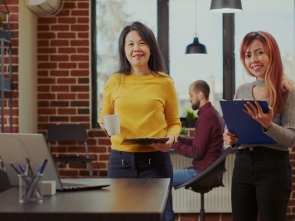 Portrait of asian business women meeting in company office, working together on e marketing and briefing about paperwork. Startup colleagues wirh clipboard planning work collaboration.